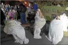  ?? PETE BANNAN – DIGITAL FIRST MEDIA ?? Residents of the Barclay Friends senior home wait under blankets as the senior care facility burns in a horrific fire late Thursday evening. Hundreds of residents were evacuated from the building after an explosion and fire destroyed the home.