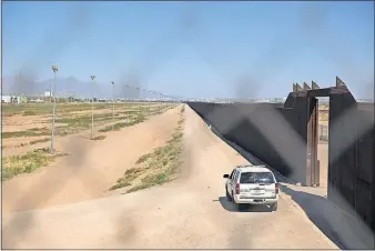  ?? [IVAN PIERRE AGUIRRE/THE NEW YORK TIMES] ?? A Border Patrol vehicle is parked next to the border fence between El Paso, Texas, and Ciudad Juarez, Mexico. Two Border Patrol agents were attacked, one fatally, in the Texas desert on Nov. 19, 2017.