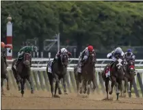  ?? SETH WENIG - THE ASSOCIATED PRESS ?? Tiz the Law (8), with jockey Manny Franco up, second from right, leads the pack down the home stretch during the152nd running of the Belmont Stakes horse race, Saturday, June 20, 2020, in Elmont, N.Y. Tiz the Law won the race.