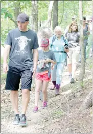  ?? Keith Bryant/The Weekly Vista ?? Jason Vore and his daughter, Lyla Vore, walk at the front of the pack during a guided hike on the Back 40 trails.