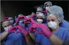  ?? (AP/Eraldo Peres) ?? Medical workers celebrate Thursday in Brasilia, Brazil, as the last three covid-19 patients are released from a field hospital at the National Stadium Mane Garrincha.