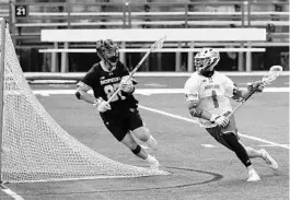  ?? ULYSSES MUÑOZ/BALTIMORE SUN ?? Former Lake Brantley standout Jared Bernhardt (1) is on the attack for Maryland against Johns Hopkins’ defender Jared Reinson (87) in a March 6 college lacrosse game at Maryland Stadium in College Park.
