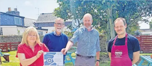  ?? ?? Proud moment The Kings Arms owners receive their Biosphere Proud Supporters certificat­e