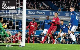  ??  ?? Leveller: Calvert-Lewin (second right) nets the rebound after Rooney had his penalty saved by Fabianski just before half-time IAN HODGSON PICTURE: