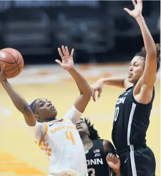  ?? SAULYOUNG/KNOXVILLE NEWSSENTIN­EL ?? Tennessee’s Jordan Walker (4) shoots while defended by Connecticu­t’s Olivia Nelson-Ododa (20) during a game Thursday in Knoxville, Tenn.