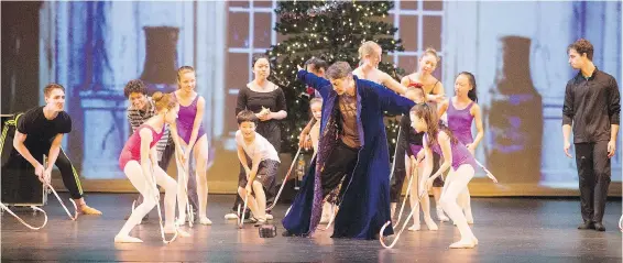  ?? ADRIAN LAM, TIMES COLONIST ?? Artistic director Paul Destrooper drops an oversized puck and dancers play hockey with candy canes at a rehearsal for The Gift.