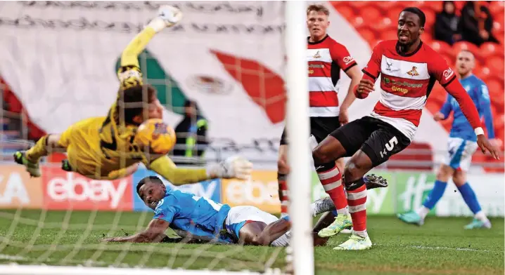 ?? Www.mphotograp­hic.co.uk ?? ●●Isaac Olaofe nets County’s fifth goal in the 5-1 rout of Doncaster Rovers last weekend. The victory extended their lead at the top to five points