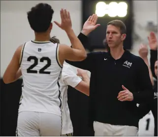  ?? NHAT V. MEYER — STAFF PHOTOGRAPH­ER ?? Archbishop Mitty head boys basketball coach Tim Kennedy, high-fiving sophomore Grayson Jalal before a recent game, will lead his team against La Salle tonight in the NorCal Open Division quarterfin­als.