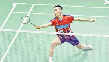  ?? — AFP photo ?? Malaysia’s Lee Chong Wei hits a return against Anthony Sinisuka Ginting of Indonesia during their quarterfin­als match at the Thomas Cup in Bangkok.