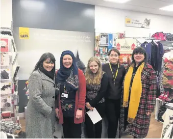  ??  ?? Cat’s eye
Rutherglen MSP Clare Haughey and Councillor Janine Calikes at the new Cat Protection shop.