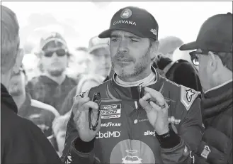  ?? JOHN RAOUX/AP PHOTO ?? Jimmie Johnson talks to team members in his garage on Saturday after a practice session for the NASCAR Daytona 500 at Daytona Internatio­nal Speedway in Daytona Beach, Fla.