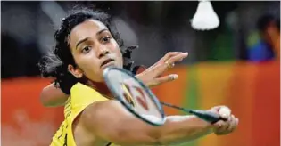  ?? – AFP ?? FIGHTER TO THE CORE: Sindhu, who was always in control of the match, sealed the championsh­ip with a forehand smash, before collapsing to the court floor on her hands and knees, physically and emotionall­y exhausted.