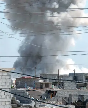  ?? — AFP ?? Smoke billows following a reported air strike on the northweste­rn Al Haramat neighbourh­ood of Mosul during the ongoing government offensive to retake the area from IS group fighters.