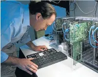  ?? Picture: BLOOMBERG ?? TESTING: An engineer examines a chip at an IBM lab. Analysts say the company should have spent more on research, less on buybacks.