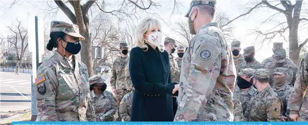  ??  ?? WASHINGTON, DC: Saying, “The Biden’s are a National Guard family,” first lady Jill Biden greets members of the National Guard with chocolate chip cookies outside the Capitol on Saturday in Washington, DC. —AFP