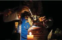 ?? ?? Colombian shaman Claudino Perez serves yage or ayahuasca during a ceremony in La Mesa.