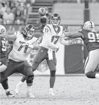  ?? Brett Coomer photos / Houston Chronicle ?? Texans quarterbac­k Brock Osweiler delivers a pass during the second quarter of the loss to the Raiders. Osweiler was 26-for-39 passing for 243 yards and a touchdown with one intercepti­on.