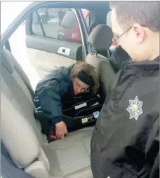  ?? Photograph submitted ?? Pea Ridge Police Cpl. Clela Eggrebrech­t and Officer Joey Ferris installed a car seat recently at a car-seat safety event at Walmart in Rogers. The two Pea Ridge Police officers, along with Sgt. Mitch Brown, spent a week learning about car seat safety...