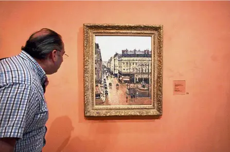  ??  ?? Impressive masterpiec­e: A visitor viewing the ‘Rue St-Honore, Apres-Midi, Effet de Pluie’ on display at the Thyssen-Bornemisza Museum in Madrid. — AP
