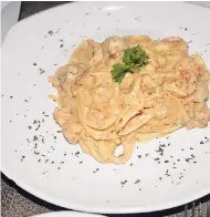  ??  ?? The chicken and shrimp Alfredo from Kenny’s Italian Restaurant is like no other.