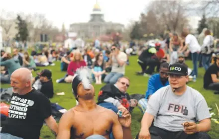  ??  ?? New York resident Anthony Parker, center, and hundreds of others participat­e in the 4/20 marijuana rally Saturday at Civic Center across fromthe state Capitol in downtown Denver. The official day is Sunday. Hyoung Chang, The Denver Post