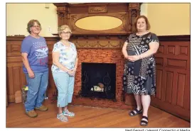  ??  ?? Library director Joan Stokes, right, with volunteers Kyna Lesko, left, and Nancy Wilmink near a fireplace in the original section of Plumb Memorial Library. Completed in 1895, the library is currently under a renovation that will highlight its original architectu­ral splendor.