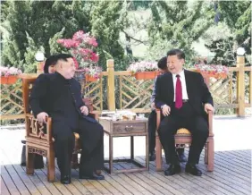  ?? FILE PHOTO BY JU PENG/XINHUA VIA AP ?? Chinese President Xi Jinping, right, speaks to North Korean leader Kim Jong Un in Dalian in northeaste­rn China’s Liaoning Province in May. Xi will not attend the celebratio­n of North Korea’s 70th anniversar­y of its founding this weekend.