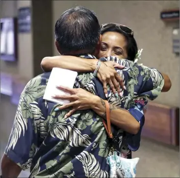  ??  ?? Alisha Keawekane-Romero of Kahului hugs uncle Ian Miyagawa on Thursday after graduating from the Maui/Molokai Drug Court Program in 2nd Circuit Court. The 63rd class featured eight graduates and included comments from Molokai-Lanai-East Maui state Rep....