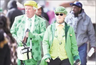  ?? Arnold Gold / Hearst Connecticu­t Media file photo ?? Ed and Karen O’Brien, of Meriden, walk down Chapel Street during the 2017 Greater New Haven St. Patrick’s Day Parade.