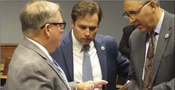  ??  ?? In this Feb. 15, 2017, file photo, Reps. Rick Edmonds (from left) R-Baton Rouge, Tanner Magee, R-Houma, and Mark Abraham, R-Lake Charles, talk about budget cut proposals ahead of the House Appropriat­ions Committee meeting in Baton Rouge, La. A tax...