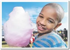  ??  ?? With everything going on around him Soloman Tefatoya, 7, had eyes only for his fairy floss.