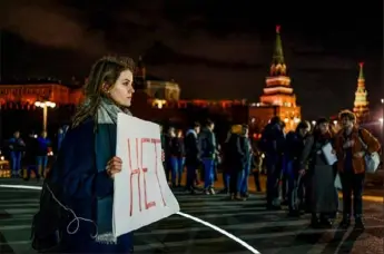  ?? Dimitar Dilkoff/AFP via Getty Images ?? A woman holds a placard reading “No” as she demonstrat­es Tuesday against the nullificat­ion of Russian President Vladimir Putin’s term near the Kremlin walls in central Moscow.