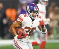  ?? John Bazemore / Associated Press ?? Giants running back Saquon Barkley carries the ball against the Falcons in Monday’s game in Atlanta.