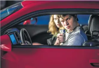  ?? Sony Pictures Entertainm­ent ?? Baby (Ansel Elgort) and Debora (Lily James) jack a car to get away in “Baby Driver.” The film uses songs to provide mood and verve in its key moments.