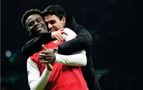  ?? (AP) ?? Hug it out: Mikel Arteta, here with Bukayo Saka, has seen his side lose back- to -back games