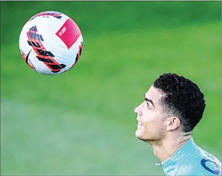  ?? AFP ?? Portugal’s national football team forward Cristiano Ronaldo eyes the ball during a training session on Monday.