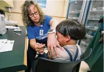  ?? PAUL VERNON / AP 2019 ?? A registered nurse with the Knox County Health Department administer­s a vaccinatio­n to a child northeast of Columbus. Last week, the CDC and WHO said a record high of nearly 40 million children missed a measles vaccine dose last year.