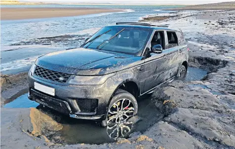  ??  ?? The new £100,000 Range Rover stuck in the sand at the nature reserve, which is a Site of Special Scientific Interest, a Special Area of Conservati­on and a Special Protection Area