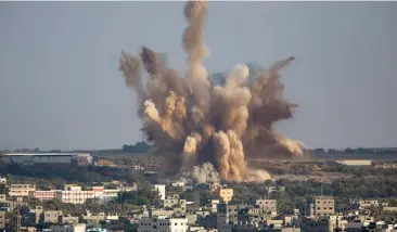  ?? — AP ?? Smoke rises in Gaza City after an Israeli airstrike on Saturday. Israeli airstrikes hit more than 20 targets and killed a top Hamas leader as militant rocket- fire continued following the collapse of a three- day truce.