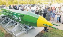  ?? AP ?? A group gathers around a GBU43B, or massive ordnance air blast weapon, on display at the Air Force Armament Museum on Eglin Air Force Base near Valparaiso, Florida.