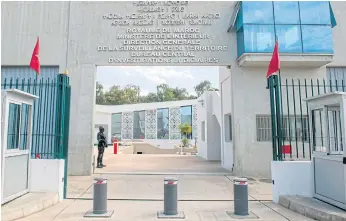  ??  ?? NO KIDS ALLOWED: A member of Morocco’s anti-terrorism security service stands guard outside the Central Bureau of Judicial Investigat­ion in Sale near the capital Rabat.