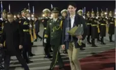  ?? SEAN KILPATRICK/THE CANADIAN PRESS ?? Prime Minister Justin Trudeau arrives in Beijing Sunday night on a trip that could start free-trade talks between Canada and China.