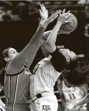  ?? Sam Craft / Associated Press ?? Texas A&M forward N'dea Jones, right, had 15 points and 10 rebounds in a 60-48 win against Georgia.
