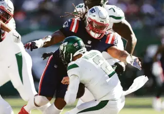  ?? Elsa / Getty Images ?? Linebacker Dont’a Hightower, here sacking New York Jets quarterbac­k Zach Wilson, and the rest of the New England Patriots defense turned the rookie’s second game into a nightmare.