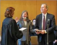  ?? PETE BANNAN — DIGITAL FIRST MEDIA ?? Chester County Clerk of Courts Yolanda Van de Krol is sworn in by President Judge Jacqueline C. Cody at ceremonies held at West Chester University Sykes ballroom Wednesday. Holding the Bible is her husband Tim Magee.