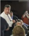  ?? MEL EVANS - THE ASSOCIATED PRESS ?? A person is ignored as she tries to ask New Jersey Gov. Chris Christie, center left, facing camera, a question after he addressed a gathering at a public forum, over plans in his proposed school funding that he says would save them money and improve...