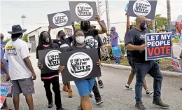  ?? MARTA LAVANDIER/AP ?? Supporters of restoring Florida felons’ voting rights march to an early voting precinct Oct. 24 in Fort Lauderdale, Florida.