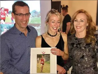  ??  ?? A smiling Mary Leech is presented with her Female Sports Star of the Year award by Aonghus O’Connor and Ciara O’Reilly.