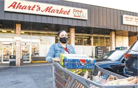  ?? APRIL GAMIZ/THE MORNING CALL ?? Longtime shopper Donna Cardenas leaves Ahart’s Market in Bethlehem on Wednesday. Cardenas said she was sad to hear the market is closing, and that she will miss the fresh baked bread available every Sunday morning.