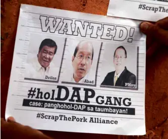  ?? NIÑO JESUS ORBETA ?? SENATE President Drilon, Budget Secretary Abad and President Aquino publicly pilloried on posters like this one for disbursing public funds under the legally questionab­le DAP scheme